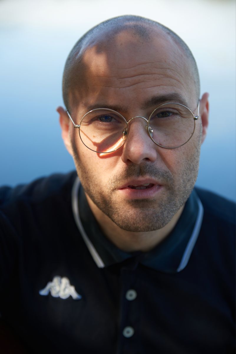 Close portrait of Marc Facchini in front of blue water